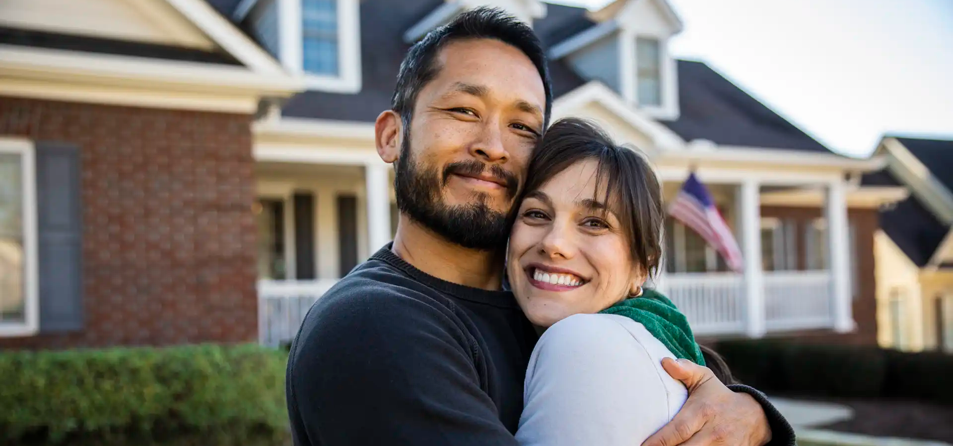 indigo-community-couple-hugging-outside-at-home
