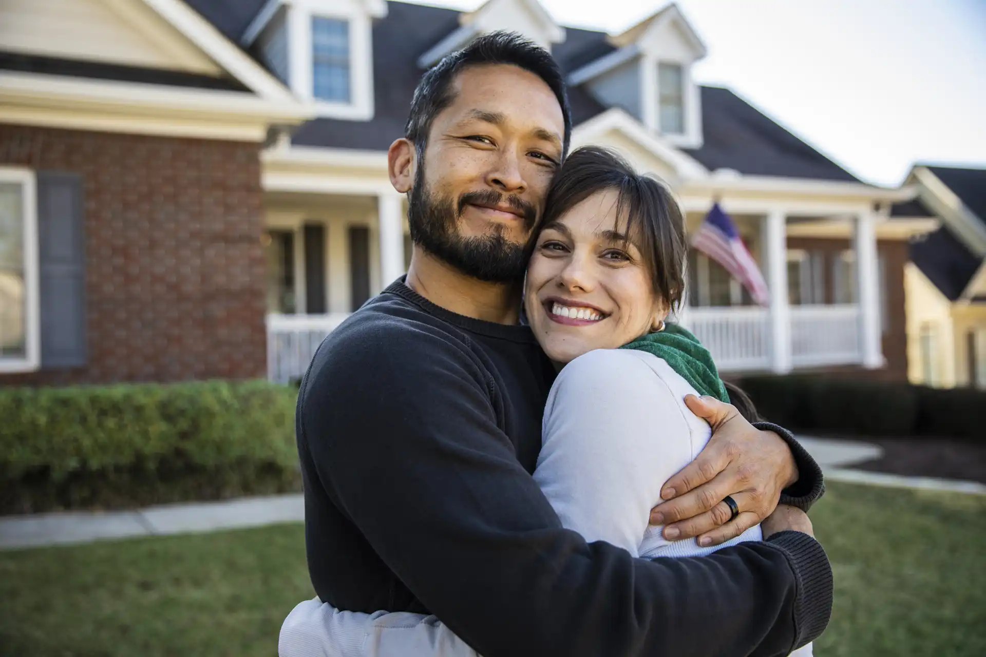 indigo-community-couple-hugging-outside-at-home